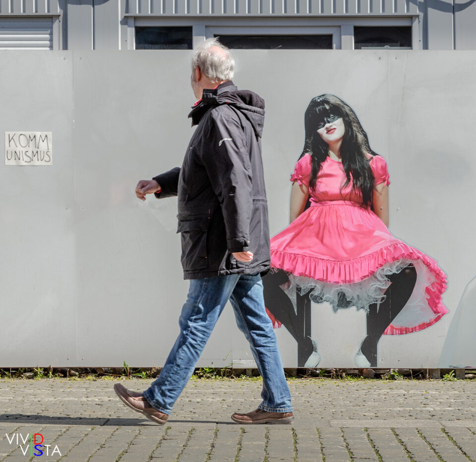 A passerby looks at advertising on a construction wall at Bebelplatz in Berlin 1F0A8104-b_vividvista